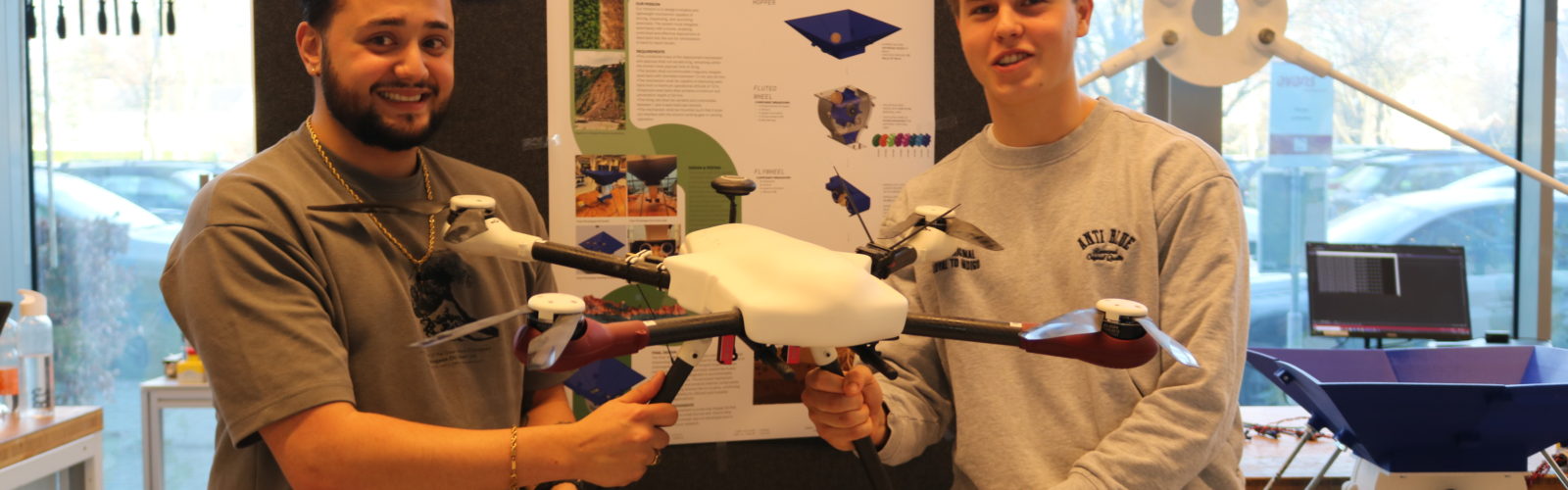 students holding seed bombing drone